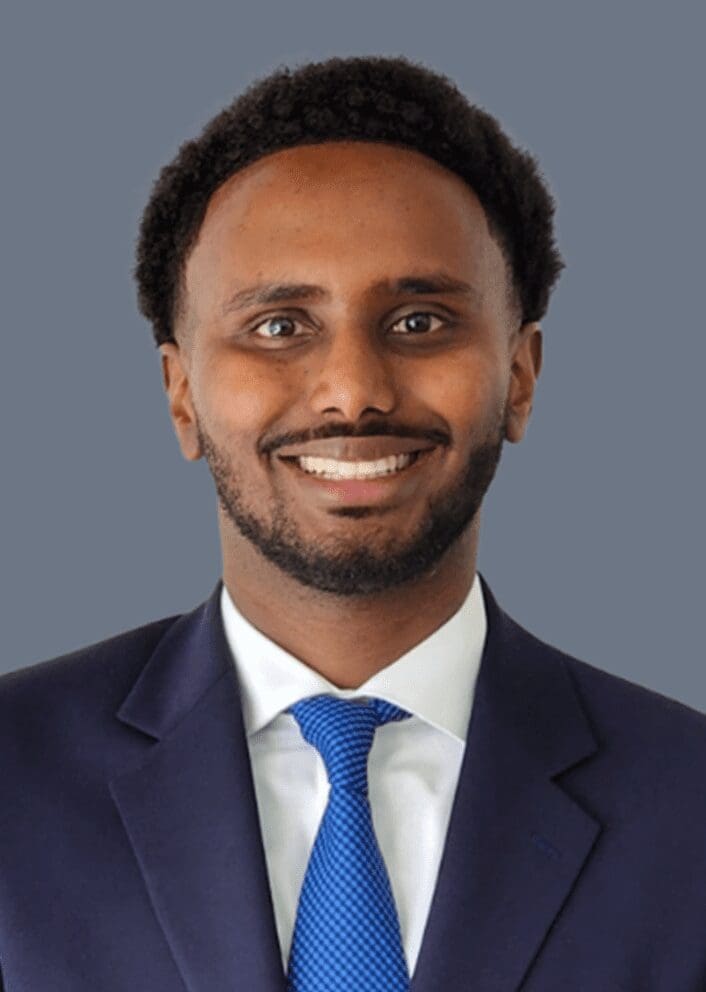 Smiling man in suit with blue tie